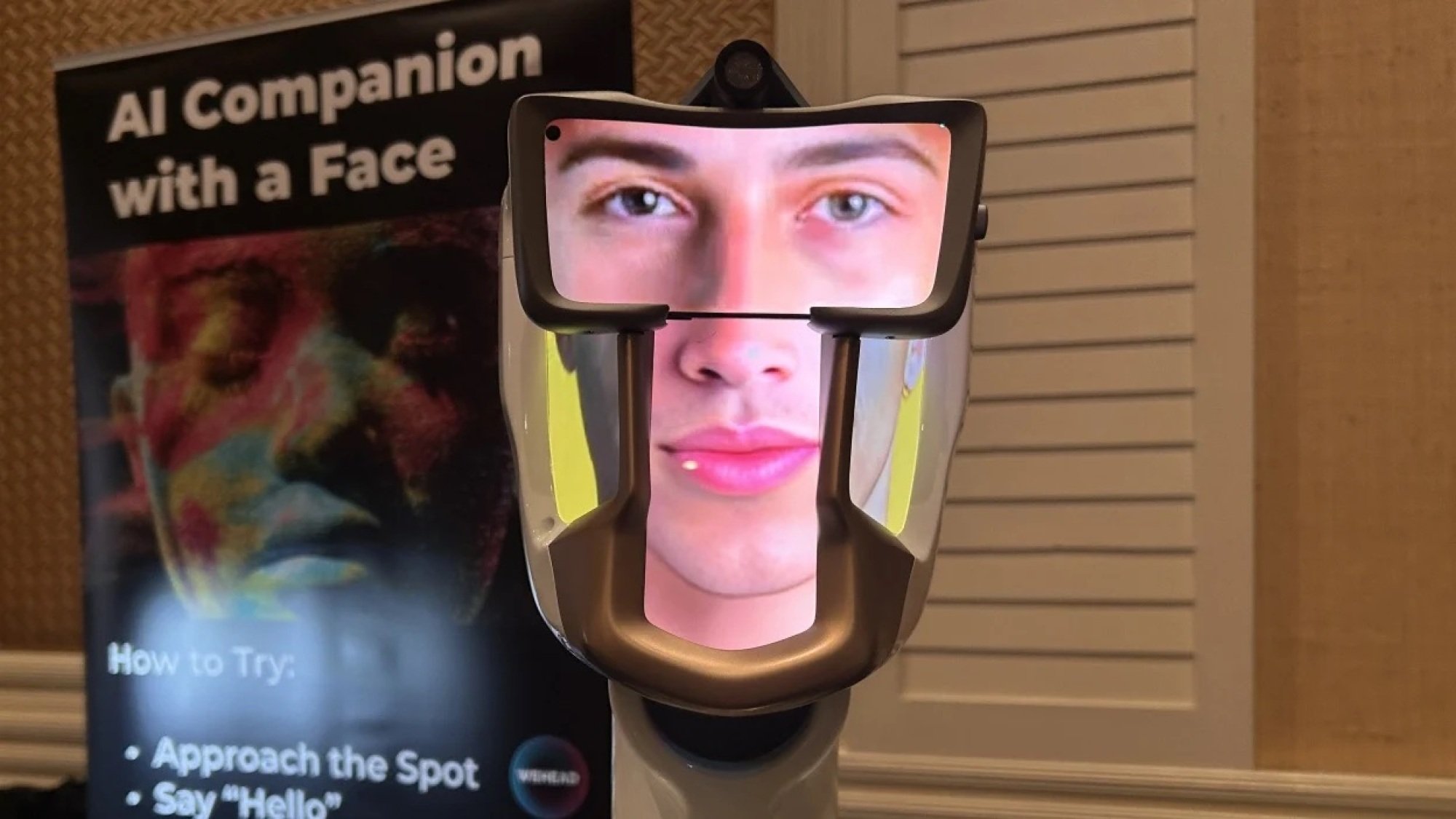 AI robotic head with photos of a face on the screen